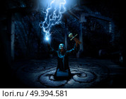 Scary witch in night forest version with lighings. Стоковое фото, агентство Ingram Publishing / Фотобанк Лори