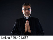 Praying hands priest portrait of male pastor. Стоковое фото, агентство Ingram Publishing / Фотобанк Лори