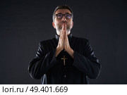 Praying hands priest portrait of male pastor. Стоковое фото, агентство Ingram Publishing / Фотобанк Лори