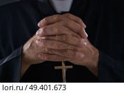 Praying hands priest portrait of male pastor. Стоковое фото, агентство Ingram Publishing / Фотобанк Лори