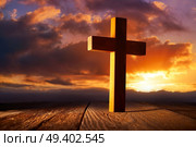 Christian wood cross on sunset sky wooden made. Стоковое фото, агентство Ingram Publishing / Фотобанк Лори