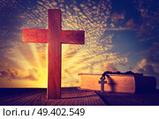 Christian wood cross on sunset sky wooden made with Bible and rosary beads. Стоковое фото, агентство Ingram Publishing / Фотобанк Лори