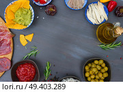 Table with spanish tapas - anchovies with peppers padron, jamon, croquetes, guacamole and olives, frame with copy space, picnic table. Table with spanish tapas. Стоковое фото, агентство Ingram Publishing / Фотобанк Лори