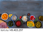 Table with plates of spanish tapas - anchovies with peppers padron, jamon, croquetes, guacamole and olives, border with copy space, picnic table. Table with spanish tapas. Стоковое фото, агентство Ingram Publishing / Фотобанк Лори