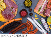 spanish tapas with salami, chorizo, lomo, jamon with red hot salsa sause and olives, picnic table, top view. Picnic table with spanish sausage tapas. Стоковое фото, агентство Ingram Publishing / Фотобанк Лори