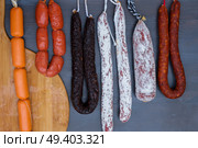 Cured meat and sausages hanging a rack at market.. Cured meat and sausages. Стоковое фото, агентство Ingram Publishing / Фотобанк Лори