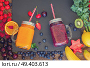 Fresh smoothy berries and orange healthy drink in glass jars with igredients, retro toned. Fresh smoothy orange drink. Стоковое фото, агентство Ingram Publishing / Фотобанк Лори