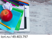 Apple with school supplies on white wooden table, top view. Apple with school supplies. Стоковое фото, агентство Ingram Publishing / Фотобанк Лори