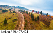 Off-road car climbing on a mountain extreme rural dirt road. Muddy hillside in autumn rainy season. Стоковое фото, агентство Ingram Publishing / Фотобанк Лори