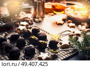 Homemade festive confectionery , pralines and truffles on dark rustic background with ingredients. Christmas sweets patisserie background with cozy candle light. Стоковое фото, агентство Ingram Publishing / Фотобанк Лори