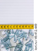 disassembled screws and wrenches metalic workshop background with yellow tape an copy space. Стоковое фото, агентство Ingram Publishing / Фотобанк Лори