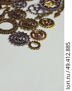 A steampunk and ancient macro about machinery made of bronze, silver and gold gears with beige background. Стоковое фото, агентство Ingram Publishing / Фотобанк Лори