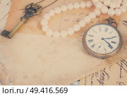 pile of old letters  and antique  clock vintage bckground with copy space, retro toned. mail  with  old clock. Стоковое фото, агентство Ingram Publishing / Фотобанк Лори