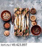 Smoked fish with spices.Cold smoked fish.Smoked capelin. Appetizing smoked fish. Стоковое фото, агентство Ingram Publishing / Фотобанк Лори