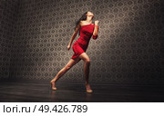 Young, pretty latin dancer practicing alone. Стоковое фото, агентство Ingram Publishing / Фотобанк Лори