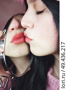 Beautiful young brunette woman kissing                                . Стоковое фото, агентство Ingram Publishing / Фотобанк Лори