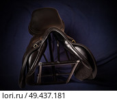 Black leather professional jumping saddle without stirrup at stand. Стоковое фото, агентство Ingram Publishing / Фотобанк Лори