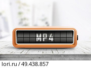 Mp4 sign on a analog device in a bright living room on a wooden desk. Стоковое фото, агентство Ingram Publishing / Фотобанк Лори