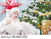 Cute little son during his first Christmas. Стоковое фото, агентство Ingram Publishing / Фотобанк Лори