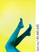 Pop art piece of young woman legs in tights against a yellow background                               . Стоковое фото, агентство Ingram Publishing / Фотобанк Лори
