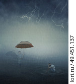 Surrealistic image as lonely, stressed man sit in the lake water below the falling rain and his angel try to help him giving an umbrella. Forgiveness, spiritual support. Стоковое фото, агентство Ingram Publishing / Фотобанк Лори