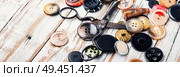 Spools of threads and buttons on wooden table. Sewing tool. Sewing tools and accessories. Стоковое фото, агентство Ingram Publishing / Фотобанк Лори