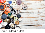 Spools of threads and buttons on wooden table.Accessories for sewing. Tools for needlework. Стоковое фото, агентство Ingram Publishing / Фотобанк Лори