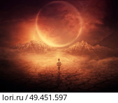 Surreal background as a young boy walks on another planet with dry and cracked ground, following a shining space object in the sky. Стоковое фото, агентство Ingram Publishing / Фотобанк Лори