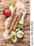 Grilled lula kebab lamb on wooden table.Asian traditional meat dish. Lamb lula kebab. Стоковое фото, агентство Ingram Publishing / Фотобанк Лори