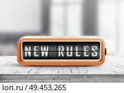 New rules alarm message on a wooden desk in a bright indoor environment. Стоковое фото, агентство Ingram Publishing / Фотобанк Лори