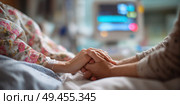 A woman is holding a man's hand in a hospital bed. Стоковое AI-изображение, AI-художник Ярославский Максим / Фотобанк Лори