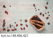 blue wooden background with cinnamon, anise, dog rose  . Стоковое фото, агентство Ingram Publishing / Фотобанк Лори