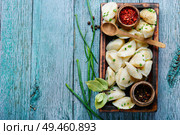 Dumplings is a Slavic dish, common in Ukrainian cuisine, in the form of boiled unleavened dough stuffed with vegetables. Ukrainian potato dumplings. Стоковое фото, агентство Ingram Publishing / Фотобанк Лори
