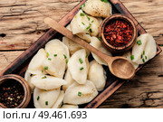 Dumplings is a Slavic dish, common in Ukrainian cuisine, in the form of boiled unleavened dough stuffed with vegetables. Ukrainian potato dumplings. Стоковое фото, агентство Ingram Publishing / Фотобанк Лори