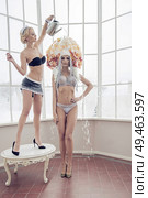 Conceptual portrait of a sensual maid watering an another woman. Стоковое фото, агентство Ingram Publishing / Фотобанк Лори