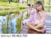 Two relaxed freinds sitting on a wet jetty - summer shot. Стоковое фото, агентство Ingram Publishing / Фотобанк Лори