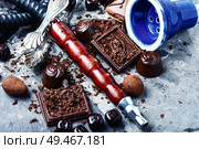 Oriental smoking hookah with a taste of chocolates. Chocolate tobacco flavor.. Shisha hookah with chocolate. Стоковое фото, агентство Ingram Publishing / Фотобанк Лори