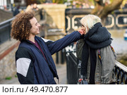 Happy couple having fun un Camden Town Little Venice, London. UK. Young woman kissing the hand of her boyfriend.. Young woman kissing the hand of her boyfriend in Camden Town Little Venice, Стоковое фото, агентство Ingram Publishing / Фотобанк Лори