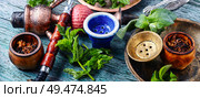 Smoking hookah with mint flavor.Shisha mint tobacco.Shisha hookah with spearmint. East hookah with spearmint. Стоковое фото, агентство Ingram Publishing / Фотобанк Лори