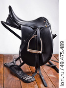 Black professional  leather dressage saddle with stirrups. Стоковое фото, агентство Ingram Publishing / Фотобанк Лори