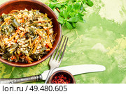 Popular food of the Middle East.Stew bulgur.Bulgur with portulak.. Stewed bulgur with portulak. Стоковое фото, агентство Ingram Publishing / Фотобанк Лори