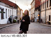 Exploring a Charming Cobblestone Street as Dusk Settles and City Lights Begin to Glow. Стоковое фото, фотограф Aleksandr Golubev / Фотобанк Лори