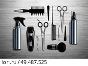 Hairdressing salon barber shop tools collection realistic top view with scissors trimmer clipper monochrome wooden background vector illustration. Стоковая иллюстрация, агентство Ingram Publishing / Фотобанк Лори
