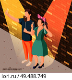 Photo booth party celebration isometric brick wall background poster with couple holding props in spotlights vector illustration. Стоковая иллюстрация, агентство Ingram Publishing / Фотобанк Лори