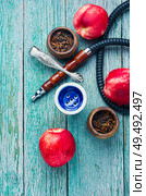 Tobacco shisha with nectarine flavor.Hookah with peach.Mouthpiece of smoking tobacco hookah. Hookah with nectarine flavor. Стоковое фото, агентство Ingram Publishing / Фотобанк Лори