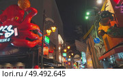 Osaka, Japan - Sep 21 2024, 4k, Panoramic view of Dotonbori street with various cafes, restaurants, bright signs and advertisements, illumination, a lot of people walking, at night, Osaka, Japan. Редакционное видео, видеограф Сергей Богомяко / Фотобанк Лори