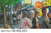 Osaka, Japan - Sep 21 2024, 4k, Panoramic view of Dotonbori street with various cafes, restaurants, bright signs and advertisements, illumination, a lot of people walking, at night, Osaka, Japan. Редакционное видео, видеограф Сергей Богомяко / Фотобанк Лори