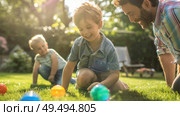 A man is kneeling down next to a little boy, engaging in conversation or attending to the child. Стоковое AI-изображение, AI-художник Данила Большаков / Фотобанк Лори
