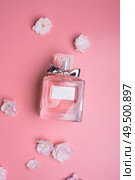  perfume bottle  with flowers  around pink   background. flat lay . Стоковое фото, агентство Ingram Publishing / Фотобанк Лори