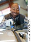 removing a part of a vehicle. Стоковое фото, агентство Ingram Publishing / Фотобанк Лори